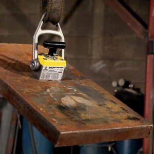 Magnetic lifter lifting a metal sheet.