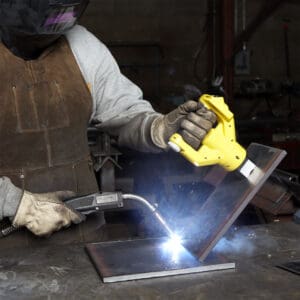 Welder working with protective gear and torch.