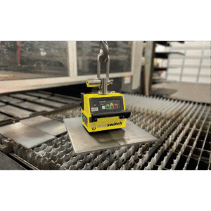 Magnetic lifter holding a metal sheet.