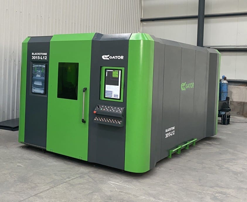 Large industrial machine with green and gray exterior.